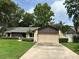 Well-maintained home featuring an attached two-car garage and a paved driveway at 9375 Woodbreeze Blvd, Windermere, FL 34786