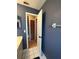 Hallway leading to other rooms with blue accent wall and white tiled floor at 9375 Woodbreeze Blvd, Windermere, FL 34786
