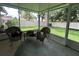 Screened lanai featuring wicker seating and views of the manicured backyard at 9375 Woodbreeze Blvd, Windermere, FL 34786