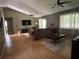 Cozy living room with hardwood floors, vaulted ceilings, ceiling fans and comfortable seating at 9375 Woodbreeze Blvd, Windermere, FL 34786