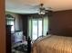 Bedroom featuring hardwood floors, ceiling fan, dresser and private access to the backyard at 9375 Woodbreeze Blvd, Windermere, FL 34786