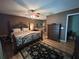 Bedroom featuring hardwood floors, ceiling fan, dresser and connecting bathroom at 9375 Woodbreeze Blvd, Windermere, FL 34786