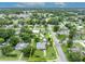Aerial view featuring the property within a suburban neighborhood with green lawns, mature trees, and street access at 1 W Pierce Ave, Orlando, FL 32809
