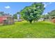 Expansive backyard featuring lush green grass, mature trees, a shed, and an above ground pool, perfect for outdoor enjoyment at 1 W Pierce Ave, Orlando, FL 32809