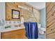 Stylish bathroom with knotty pine accent wall, modern vanity, and unique design elements at 1 W Pierce Ave, Orlando, FL 32809