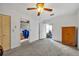 Bright bedroom with neutral walls and carpet, access to kitchen and living spaces, and closet storage at 1 W Pierce Ave, Orlando, FL 32809