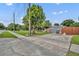 Concrete driveway leading to a home with mature trees and a fenced front yard, offering ample parking space at 1 W Pierce Ave, Orlando, FL 32809