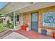 Inviting front porch with unique wood details, colorful planters, and cozy bench seating at 1 W Pierce Ave, Orlando, FL 32809