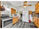 Bright kitchen with stainless appliances, wood cabinets, and view to adjacent living area at 1 W Pierce Ave, Orlando, FL 32809
