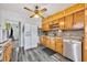 Well-lit kitchen with wooden cabinetry, stainless steel appliances, and hardwood floors at 1 W Pierce Ave, Orlando, FL 32809