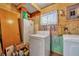 Functional laundry room with washer, dryer, and ample storage space, plus natural light from the window at 1 W Pierce Ave, Orlando, FL 32809