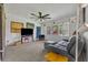 Bright living room features a large window, a ceiling fan, and comfortable seating at 1 W Pierce Ave, Orlando, FL 32809