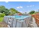 Above ground swimming pool with ladder, offering a refreshing retreat in the backyard with shed nearby at 1 W Pierce Ave, Orlando, FL 32809
