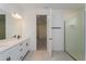 Bright bathroom featuring double vanity, quartz countertop, modern fixtures, and glass enclosed shower at 10061 Dulbecco St, Orlando, FL 32827