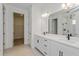 Modern bathroom featuring double sinks, white cabinets, and a walk-in shower, creating a spa-like atmosphere at 10061 Dulbecco St, Orlando, FL 32827