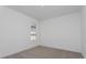 Minimalist bedroom with neutral carpeting, showcasing a bright, window-lit space at 10061 Dulbecco St, Orlando, FL 32827