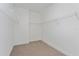 Walk-in closet with shelving units and neutral carpet; ready for organizing your wardrobe at 10061 Dulbecco St, Orlando, FL 32827