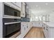 Well-equipped kitchen features stainless steel appliances, sleek white cabinetry, and a modern backsplash at 10061 Dulbecco St, Orlando, FL 32827