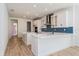 Modern kitchen featuring white cabinets, stainless steel appliances, and a stylish backsplash, perfect for cooking at 10061 Dulbecco St, Orlando, FL 32827