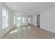 Bright, open-concept living room features wood-look tile flooring, recessed lighting, and large windows at 10061 Dulbecco St, Orlando, FL 32827