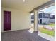 Covered patio featuring brick pavers and glimpses of the neighborhood and a dark purple door at 10061 Dulbecco St, Orlando, FL 32827