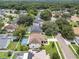 Aerial view of a neighborhood with mature trees and homes with private pools at 1109 Needlewood Loop, Oviedo, FL 32765