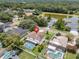 Aerial view of a home with pool and well-manicured lawn near a serene lake at 1109 Needlewood Loop, Oviedo, FL 32765