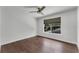 This bedroom features hardwood floors, ceiling fan, and a large window at 1109 Needlewood Loop, Oviedo, FL 32765