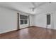 A bright bedroom has hardwood floors, a ceiling fan, and large windows at 1109 Needlewood Loop, Oviedo, FL 32765