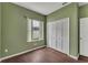 Small bedroom with hardwood floors, closet, and window with natural light. Ready for your personal touch at 1109 Needlewood Loop, Oviedo, FL 32765