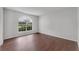 Bright bedroom with hardwood floors, a large arched window, and neutral paint at 1109 Needlewood Loop, Oviedo, FL 32765