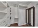 Walk-in closet features custom organizers and shelves and a wood floor at 1109 Needlewood Loop, Oviedo, FL 32765