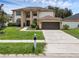 Beautiful two-story home with a two-car garage and a landscaped front yard at 1109 Needlewood Loop, Oviedo, FL 32765