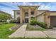 Stunning exterior with lawn and landscaping featuring a grand columned entryway at 1109 Needlewood Loop, Oviedo, FL 32765