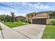 Exterior view of home showcasing manicured lawn, driveway, and two-car garage at 1109 Needlewood Loop, Oviedo, FL 32765