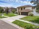 Well-manicured lawn complements the home's elegant exterior and attached two-car garage at 1109 Needlewood Loop, Oviedo, FL 32765