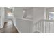 Bright hallway featuring hardwood floors, white walls, and a staircase with natural light at 1109 Needlewood Loop, Oviedo, FL 32765