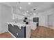 Modern kitchen featuring white cabinets, a breakfast bar, pendant lighting and stainless steel appliances at 1109 Needlewood Loop, Oviedo, FL 32765