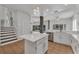 Bright kitchen featuring a center island, modern appliances, and an open view of the backyard pool at 1109 Needlewood Loop, Oviedo, FL 32765
