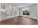 Sunlit living room features hardwood floors, a large window, and an open floor plan at 1109 Needlewood Loop, Oviedo, FL 32765
