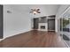 Spacious living room with hardwood floors, a fireplace, and sliding doors to a patio at 1109 Needlewood Loop, Oviedo, FL 32765