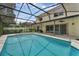 Spacious backyard with a pool, screened enclosure, covered patio, and manicured landscaping at 1109 Needlewood Loop, Oviedo, FL 32765