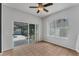 Sunroom with tile flooring, ceiling fan, and glass doors leading to a screened-in patio and fenced yard at 1109 Needlewood Loop, Oviedo, FL 32765