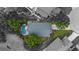 Aerial view of home with pool, patio and lush landscaping at 1130 Woodsong Way, Clermont, FL 34714
