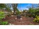 Lush backyard with mature trees for shade, plus mulch, landscape beds and a fire pit at 1130 Woodsong Way, Clermont, FL 34714