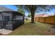 Grassy backyard with screen-enclosed patio at 1130 Woodsong Way, Clermont, FL 34714