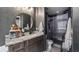 Modern bathroom with a vanity, round mirror, and glass-enclosed shower at 1130 Woodsong Way, Clermont, FL 34714