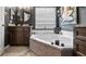 Bathroom featuring a corner tub, neutral decor, and a window for natural light at 1130 Woodsong Way, Clermont, FL 34714