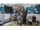 Bedroom with a loft bed, desk, chair, storage, and wood laminate flooring at 1130 Woodsong Way, Clermont, FL 34714