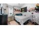 Bedroom featuring a queen bed, red brick accent wall, and natural lighting at 1130 Woodsong Way, Clermont, FL 34714